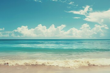 Obraz premium Relaxing beach scene with gentle waves and fluffy white clouds