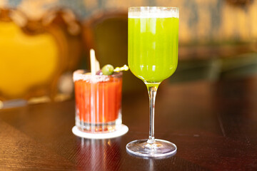 red and green cocktails on the table in the establishment