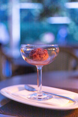 a scoop of raspberry sorbet in a glass