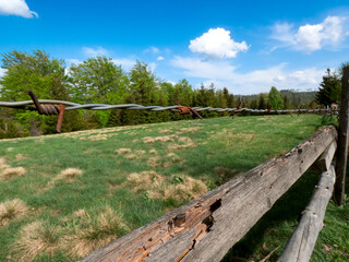 wooden fence with barb wire in the field