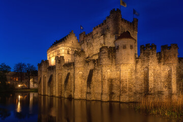 Stunning Gravensteen castle or Counts of Flanders, medieval fortress, historic city center of Ghent, Belgium. Scenic cityscape, view of city architecture at twilight, outdoor travel background