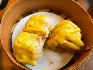 Siomay Bandung is a traditional West Javanese street food served with peanut sauce. A Bandung siomay seller who is taking dumplings to be wrapped