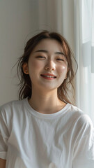 A striking portrait of a young Asian woman wearing an white t-shirt, exuding natural beauty and contemporary style.