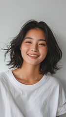 A striking portrait of a young Asian woman wearing an white t-shirt, exuding natural beauty and contemporary style.