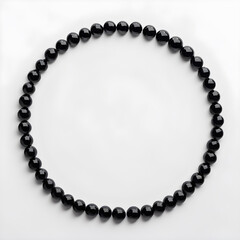 Obraz premium Black beads on a white background in the form of a circle.
