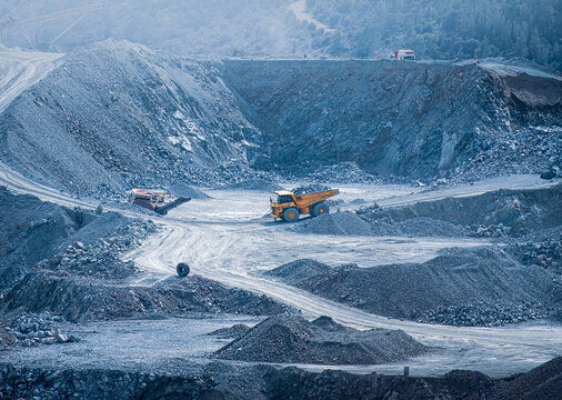 Industrial diabase quarry with heavy machinery and dump trucks in Parekklisia, Cyprus