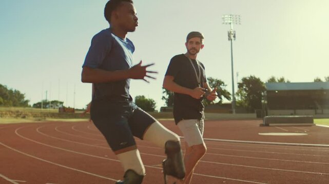Black Para-runner on the track with his coach