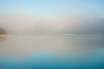 blue lake in dawn fog, nice autumn background