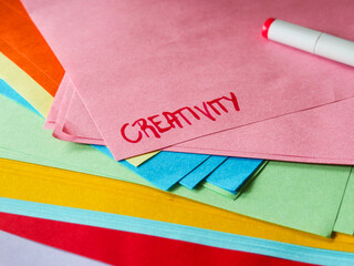 The word creativity written on paper. Message. Colorful stationary paper and arts and crafts. Hobby activities.