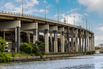 The patched and repaired supporting concrete structures of the East section of the Toronto Gardiner Expressway seen from the Villiers Island in the port lands