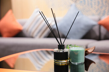Perfumes or Reed diffuser are decorated on the living room table.