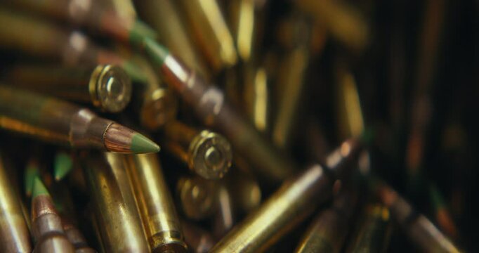5.56 bullets being grabbed and loaded into a magazine