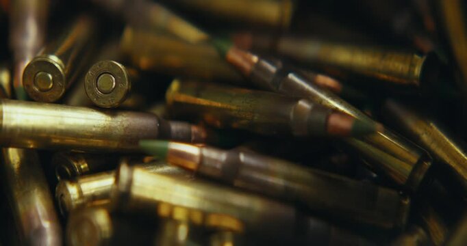 5.56 bullets being grabbed and loaded into a magazine