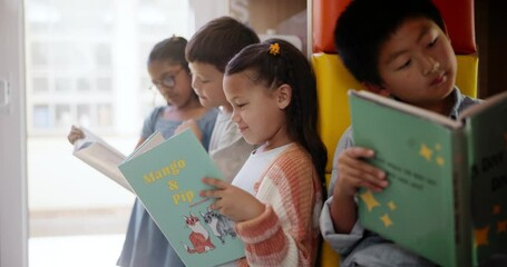 Assessment, children and reading in classroom together for educational development, group learning and growth. Students, book and studying in school for support, knowledge and storytelling or bonding - Powered by Adobe