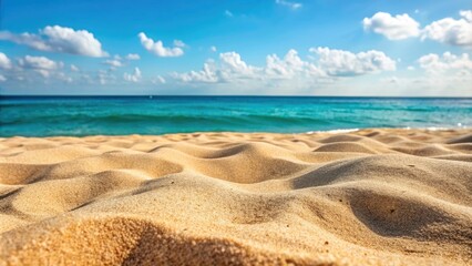 Obraz premium Sunny beach with golden sand and blue sky.
