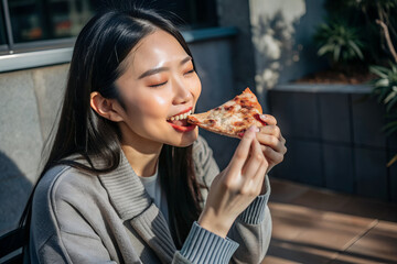 Lifestyle of a beautiful Asian woman eating pizza