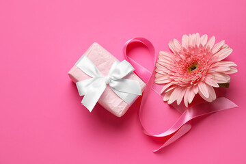 Composition with figure 8 made of ribbon, gerbera flower and gift box on pink background. International Women's Day celebration