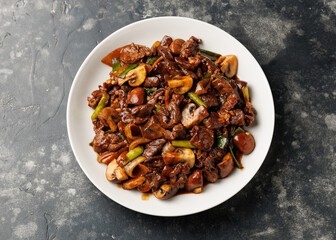 Beef Mushroom Stir Fry with ginger and garlic in a white plate