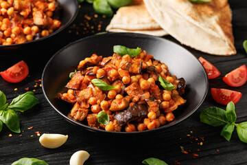 Eggplant and Chickpea Stew in tomato sauce, garlic, spices and pita bread. Healthy food