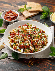 Pearl Couscous salad with sun dried tomatoes, chickpeas and feta cheese. healthy food