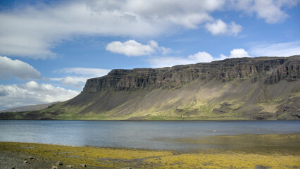 Icelandic landscape with mountains, fjord and blue sky with clouds, Hvalfjördur