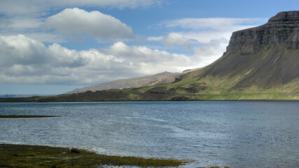 Icelandic landscape with mountains, fjord and blue sky with clouds, Hvalfjördur