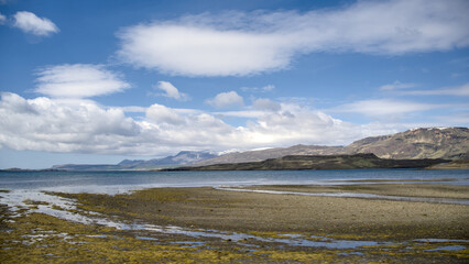 Icelandic landscape with mountains, fjord and blue sky with clouds, Hvalfjördur