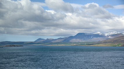 Icelandic landscape with mountains, fjord and blue sky with clouds, Hvalfjördur