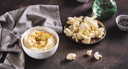Homemade creamy cauliflower soup in a bowl on the table web banner