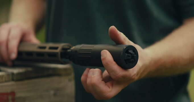 Young man at gun range preparing an AR-15 for use