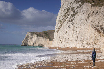 Person walking on the british beach, Jurassic Coast, Dorset, UK