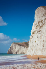 Person walking on the british beach, Jurassic Coast, Dorset, UK