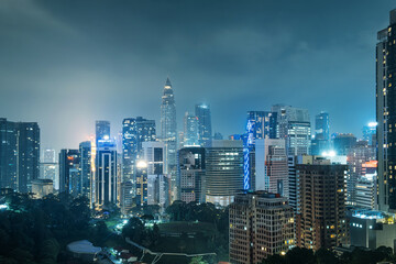 Obraz premium Aerial view of Kuala Lumpur city with high-rise buildings and skyscrapers at night, Malaysia. Cityscape of Asian city with modern architecture. Travel and tourism background