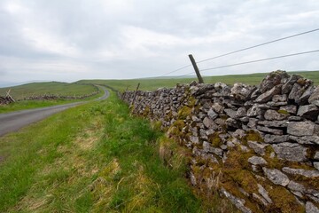 stone wall and road, landscape in yorkshire, england