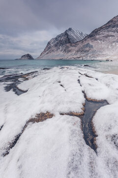 Winter scenery at Haukland Beach, Lofoten with snowy shores