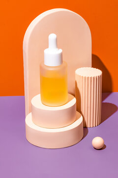 Minimalist product display with dropper bottle and podiums