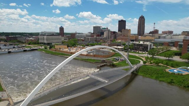 DES MOINES - 6.24.2024 - Great aerial view moving over a curved river bridge in downtown Des Moines, Iowa.