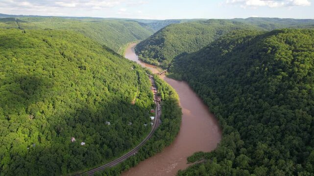 WEST VIRGINIA - 7.5.2024 - Excellent aerial footage moving alongside the New River and its nearby railroad in West Virginia.