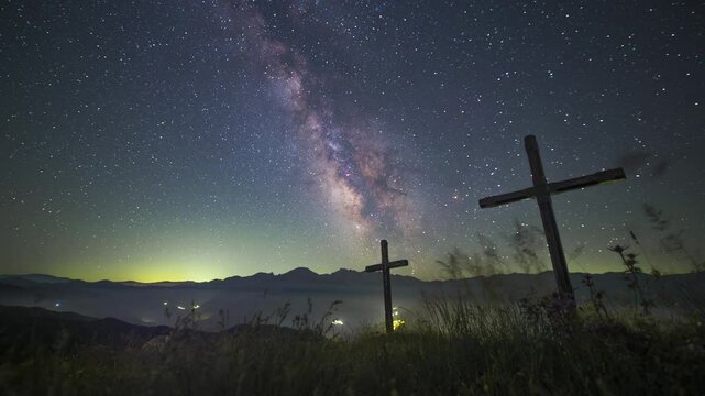 Timelapse of the night sky and milky way over the crosses of the Ermita del Alba, Quiros, Asturias, Spain