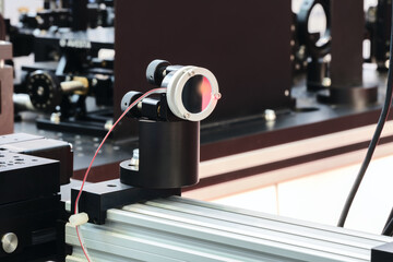 Experiment with laser device in optical laboratory. Experiment in optic lab with laser device.