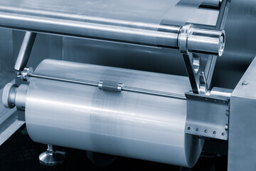 Automatic polyethylene plastic bag production machine with lighting effect. Close-up of the roller...