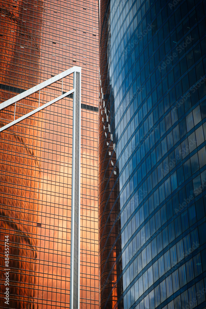 Poster a tall building with many windows and a cloudy sky in the background