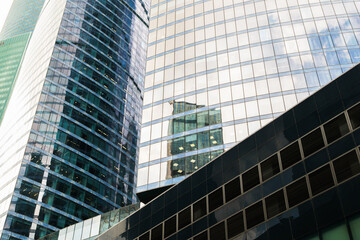 A tall building with many windows and a cloudy sky in the background