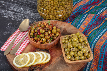 Homemade crushing olive making. Fresh green olives are breaking one by one. Crushing olives with stone. Preparing pickled olives in Turkish style. (Turkish name; kirma zeytin). Pickled Green Olives.