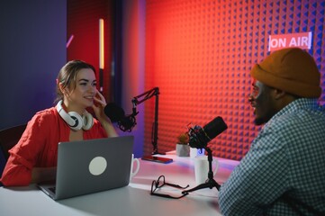 Man and woman livestreaming online discussion on podcast episode, recording live for internet...