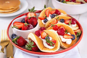 Pancake tacos, sweet breakfast tacos with whipped cream and berry