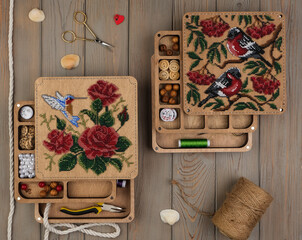 Tools and beads for making handmade jewelry on wooden background, top view