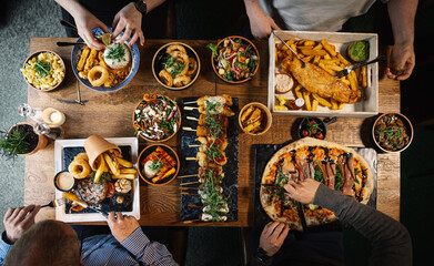 Overhead Shot of People Eating Traditional Pub Dishes