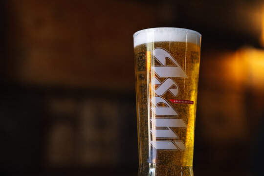 Refreshing Pint of Asahi Lager on Wood Surface Close Up