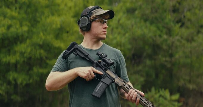 Portraits of a young man at a gun range